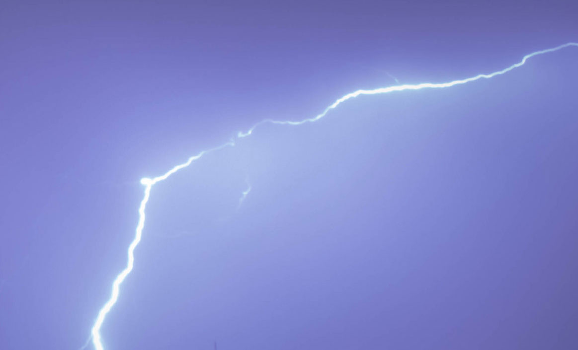 Lightning streaks across the sky during a thunderstorm.