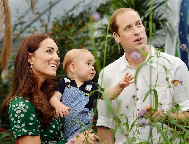 This photo taken Wednesday, July 2, 2014, and released Monday, July 21, 2014, to mark Prince George\’s first birthday, shows Britain\’s Prince William and Kate Duchess of Cambridge and the Prince during a visit to the Sensational Butterflies exhibition at the Natural History Museum, London.
