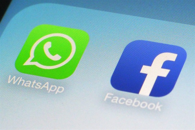This Feb. 19, 2014 file photo shows the WhatsApp and Facebook app icons on an iPhone in New York. 