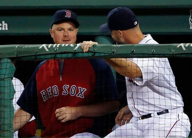Boston Red Sox pitcher Jon Lester, left, chats with catcher David Ross during a baseball game against the Toronto Blue Jays at Fenway Park in Boston, Tuesday, July 29, 2014. 