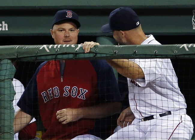 Boston Red Sox pitcher Jon Lester, left, chats with catcher David Ross during a baseball game against the Toronto Blue Jays at Fenway Park in Boston, Tuesday, July 29, 2014. 