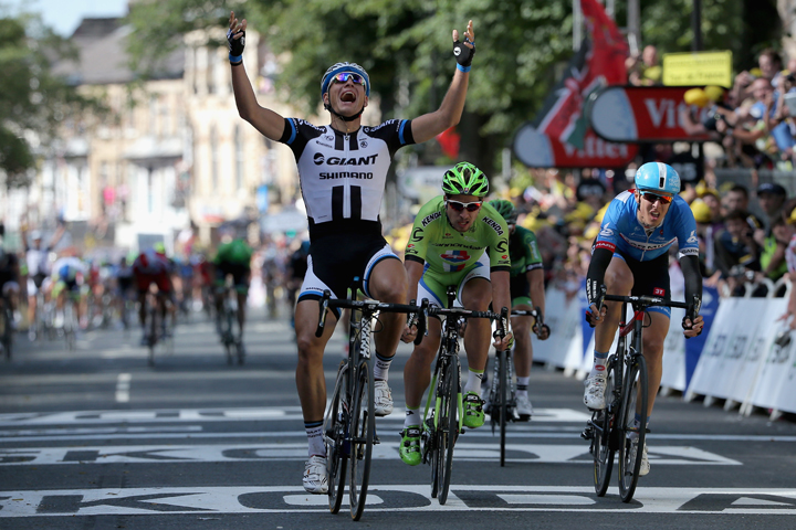 Marcel Kittel of Germany and Team Giant-Shimano celebrates his victory ahead of Peter Sagan of Slovakia and Cannondale in second place and Ramunas Navardauskas of Lithuania and Garmin-Sharp in third place in stage one of the 2014 Tour de France.