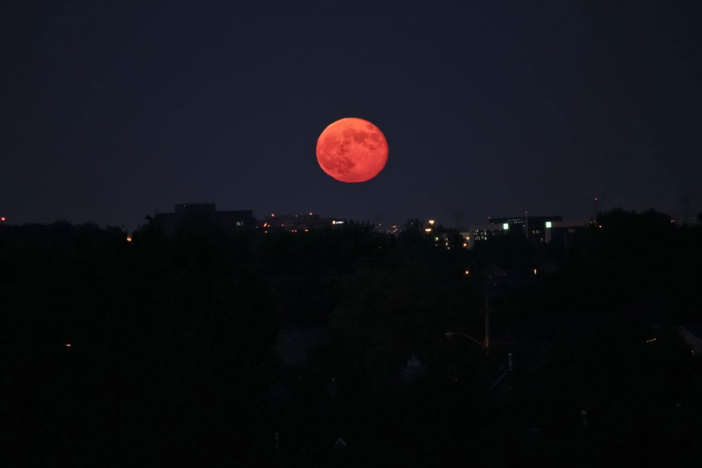 An example of the illusion of a setting (or rising) moon appearing much larger than normal (this was not a “supermoon”).