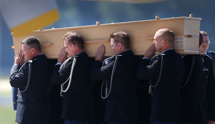 A numbered coffin carried by Dutch military personnel contains an unidentified body from the crash of MH17 on July 23, 2014 at Eindhoven airport, Netherlands.