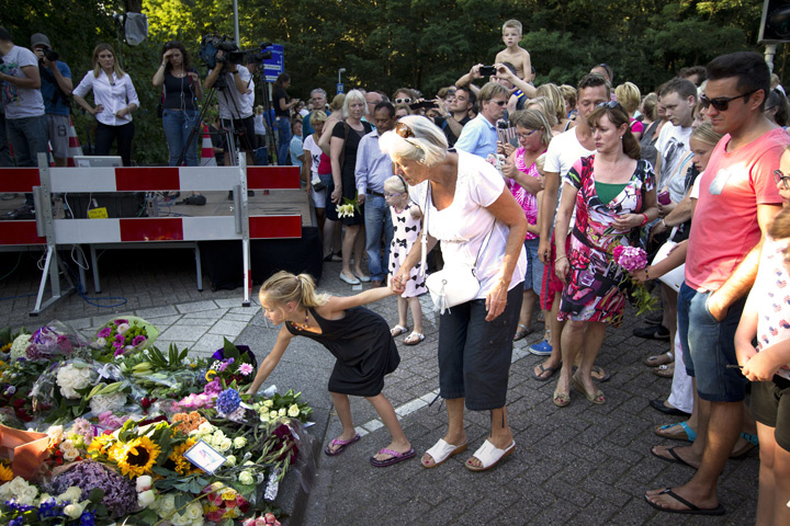 Mourners lay flowers at the entrance of the Korporaal van Oudheusdenkazerne, a military establishment where the bodies of the downed Malaysia Airlines flight MH17 will be examined and identified on July 23, 2014 in Hilversum.