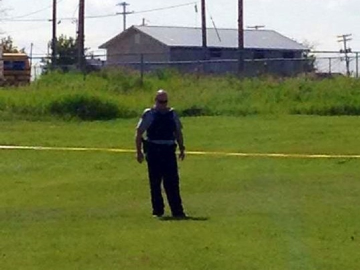 An RCMP officer at the scene of a shooting in Norway House, MB on July 20, 2014.
