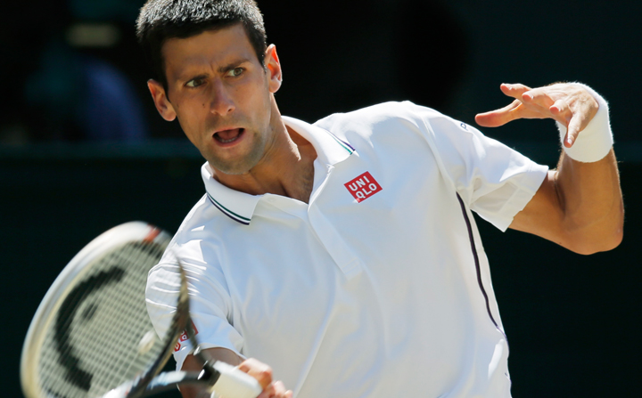 Novak Djokovic of Serbia plays a return to Grigor Dimitrov of Bulgaria during their men’s singles semifinal match at the All England Lawn Tennis Championships in Wimbledon, London, Friday, July 4, 2014.