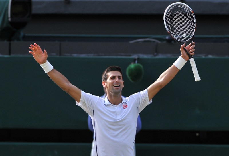 Novak Djokovic celebrates winning his men's singles final match against Switzerland's Roger Federer on day thirteen of the 2014 Wimbledon Championships at The All England Tennis Club in Wimbledon, southwest London, on July 6, 2014. AFP PHOTO / GLYN KIRK.