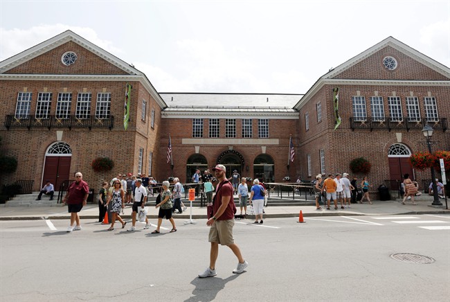Fans walk outside the Baseball Hall of Fame and Museum on Friday, July 25, 2014, in Cooperstown, N.Y.
