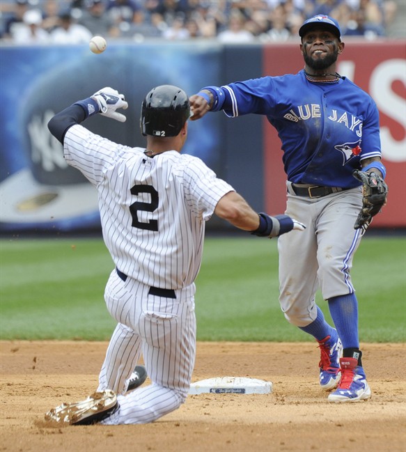New York Yankees' Derek Jeter is out at second as Toronto Blue Jays shortstop Jose Reyes, right, throws to first attempting to get Jacoby Ellsbury at first during the fifth inning of a baseball game Saturday, July 26, 2014, at Yankee Stadium in New York. Ellsbury was safe at first. (AP Photo/Bill Kostroun).