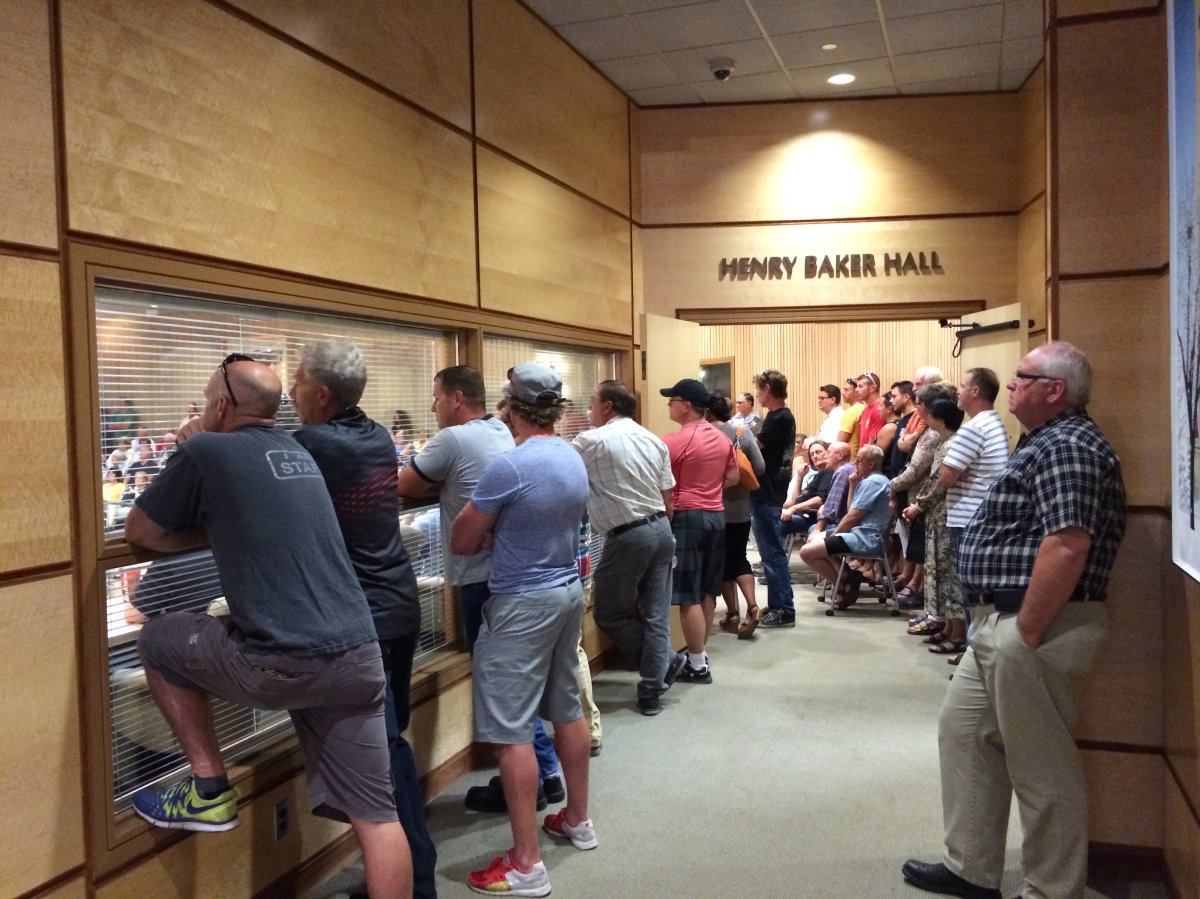 More than a hundred former and current civic employees pile into council chambers Monday evening.
