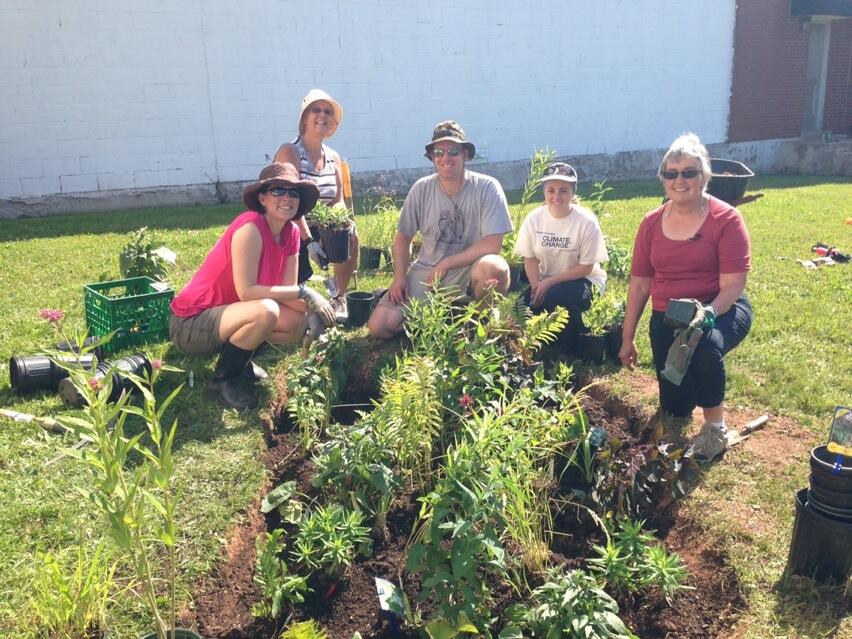 Volunteers pose with their completed rain garden on Saturday, July 12 in Dorchester, NB.