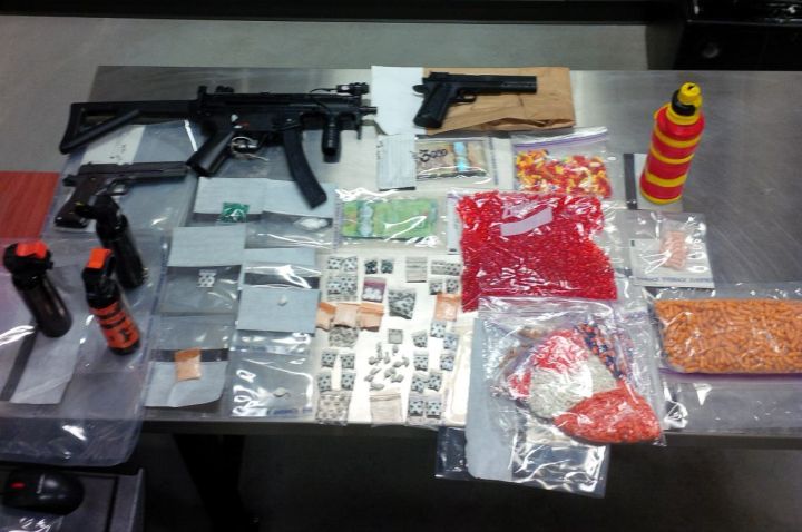 Three men are facing charges after numerous drugs, replica firearms and cash were seized from a property in Red Deer. 