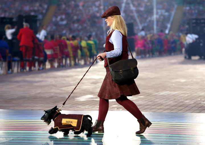 A Scottish Terrier walks with his handler as the team name bearer for India during the Opening Ceremony for the Glasgow 2014 Commonwealth Games at Celtic Park on July 23, 2014 in Glasgow, Scotland.