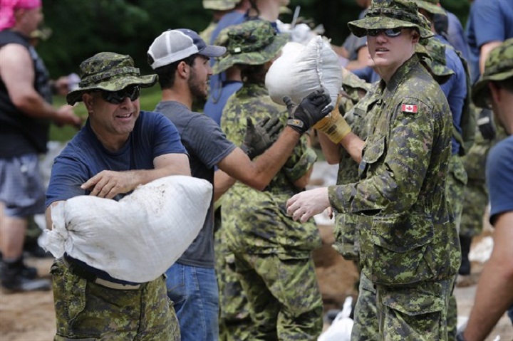 Soldiers from 17 Wing in Winnipeg sandbag in St. Francois Xavier, Man., Tuesday.