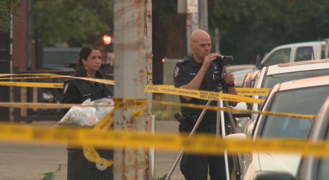 Edmonton police investigate the death of a male who was shot near Whyte Avenue, Sunday, July 20, 2014. 