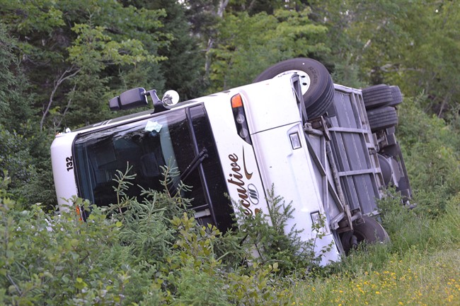 A tour bus is overturned on the Cabot Trail highway in Nova Scotia on July 13, 2014.