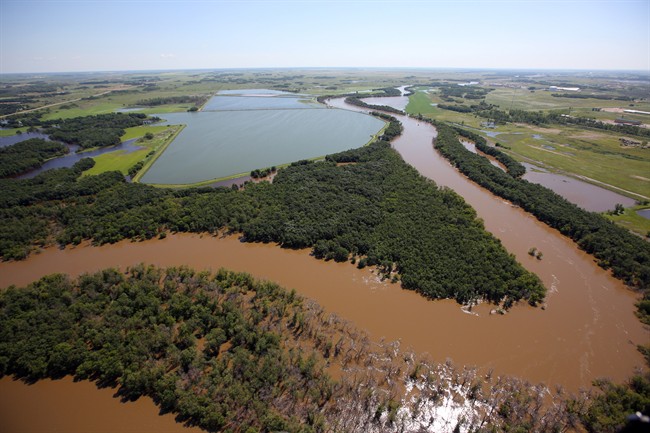 The swollen Assiniboine River covers farmland east of Brandon, Man. as seen from the air on Sunday, July 6, 2014.