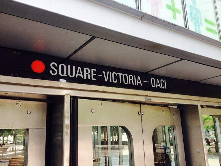 A glimpse of signs showing off the new name for Victoria Square metro station in Montreal on July 29, 2014.