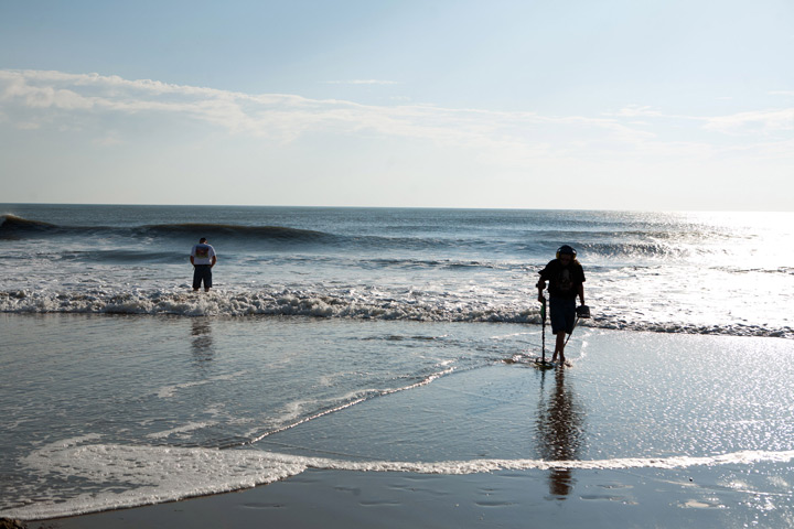 Beachcombers check the surf in Virginia Beach, Virginia.
