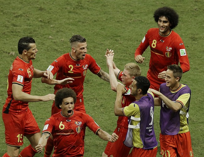 Belgium's Kevin De Bruyne, center right, celebrates scoring the opening goal during the World Cup round of 16 soccer match between Belgium and the USA at the Arena Fonte Nova in Salvador, Brazil, Tuesday, July 1, 2014.