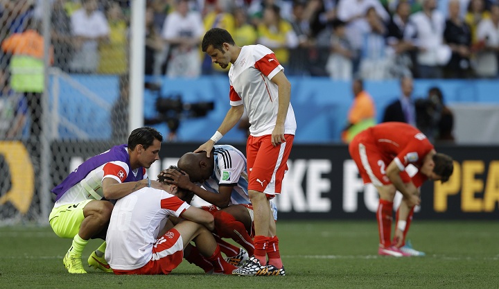 Switzerland's players react after the World Cup round of 16 soccer match between Argentina and Switzerland at the Itaquerao Stadium in Sao Paulo, Brazil, Tuesday, July 1, 2014. 