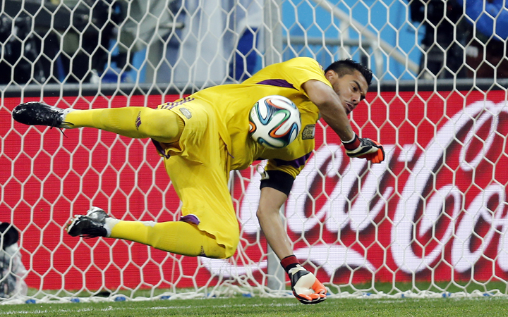 Argentina's goalkeeper Sergio Romero saves a shot from the penalty spot by Netherlands' Ron Vlaar in the shoot-out of the World Cup semifinal soccer match between the Netherlands and Argentina at the Itaquerao Stadium in Sao Paulo, Brazil, Wednesday, July 9, 2014.