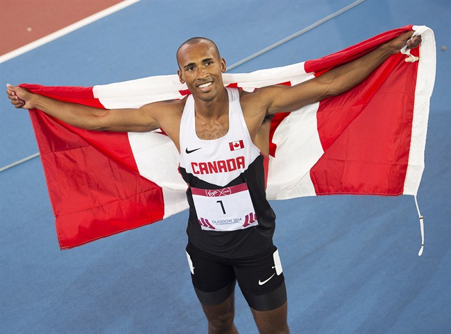 Canada's Damian Warner displays the flag after winning the gold medal in decathlon at Hampden Park at the Commonwealth Games in Glasgow, Scotland on Tuesday, July 29, 2014.