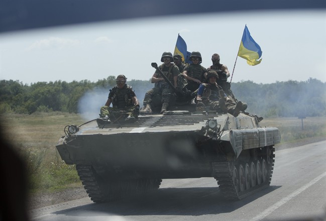 Ukrainian troops move near the village of Debaltseve, Donetsk region, eastern Ukraine, Thursday, July 31, 2014. (AP Photo/Dmitry Lovetsky).