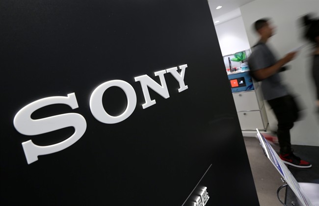 Visitors walk past a logo of Sony at Sony Building in Tokyo Thursday, July 31, 2014. 