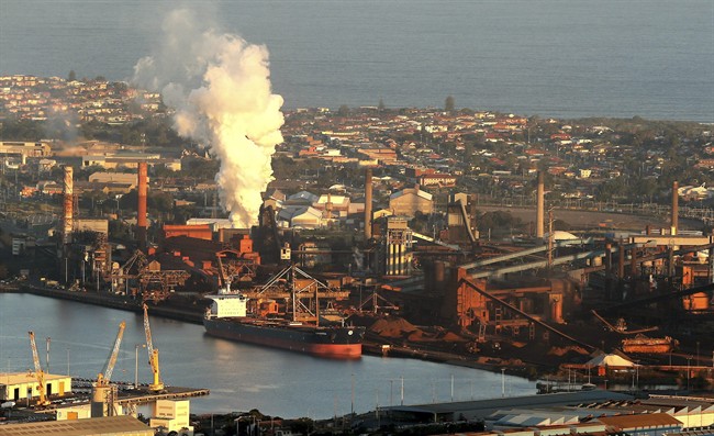 Smoke billows out of a chimney stack of steel works factories in Port Kembla, south of Sydney.