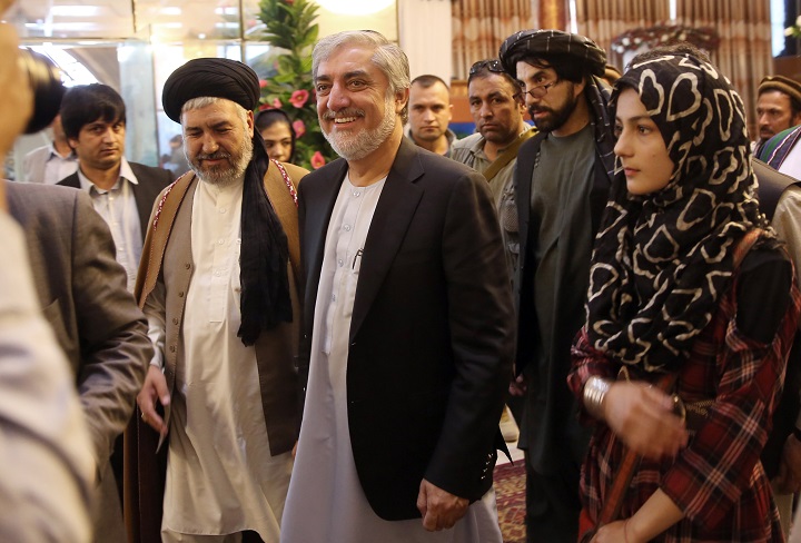 Afghan presidential candidate Abdullah Abdullah, center, arrives for a rally at a wedding hall in Kabul, Afghanistan, Thursday, Aug. 21, 2014.