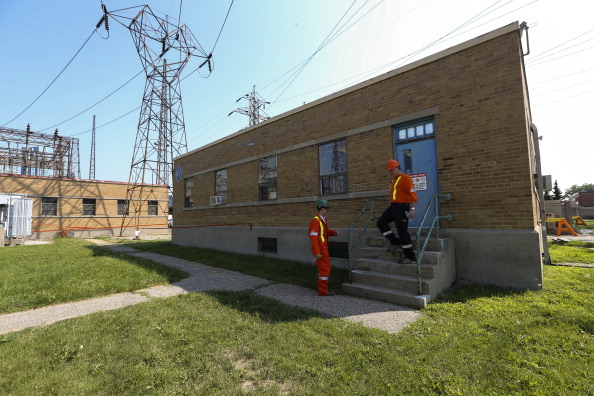 Hydro One workers walk down the stairs of the Manby transformer station in Etobicoke on July 17, 2013. 