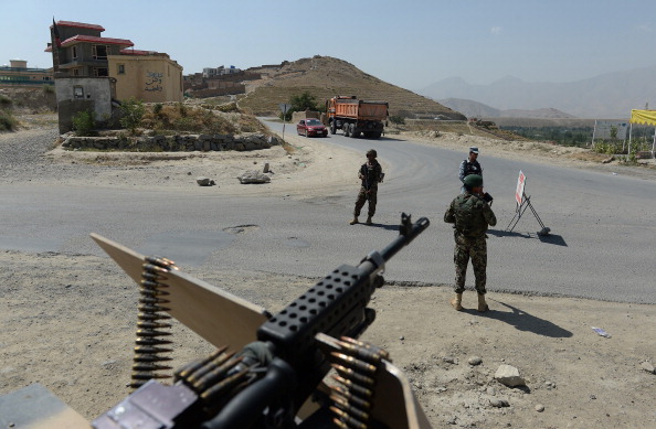 Afghan National Army (ANA) soldiers keep watch at a checkpoint near the Marshal Fahim National Defense University, a training complex on the outskirts of Kabul on August 6, 2014.