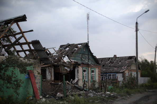 A picture shows houses destroyed by combat between the Ukrainian armed forces and pro-Russian militants, in the village of Senyonovka, near the eastern Ukrainian city of Slavyansk, on August 7, 2014. Fighting raged on in Ukraine's industrial east, where local authorities have warned of a looming humanitarian catastrophe. NATO chief Anders Fogh Rasmussen urged Russia to "step back from the brink" during a visit to Kiev on Thursday and vowed support for Ukraine as fears mounted that Moscow was preparing to send troops into the conflict-torn east of the country. 