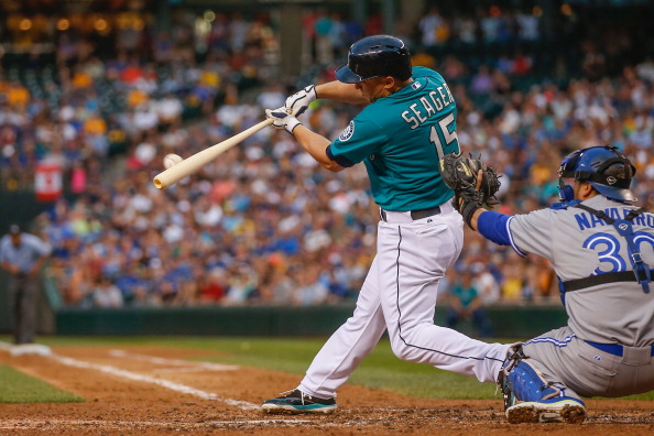 Kyle Seager #15 of the Seattle Mariners hits an RBI sacrifice fly in the fourth inning  against the Toronto Blue Jays at Safeco Field on August 11, 2014 in Seattle, Washington.  (Photo by Otto Greule Jr/Getty Images).