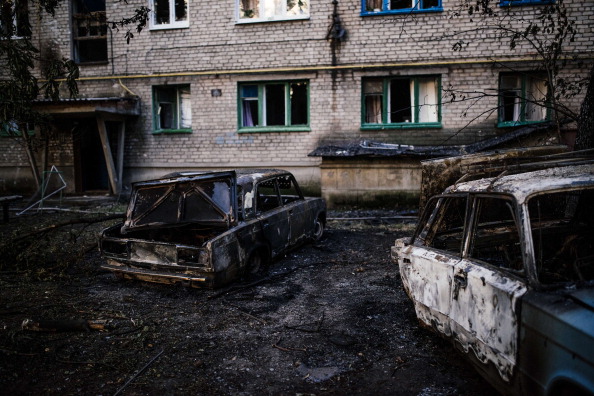 Burned cars are seen after shelling in the town of Yasynuvata near the rebel stronghold of Donetsk on August 12, 2014. 