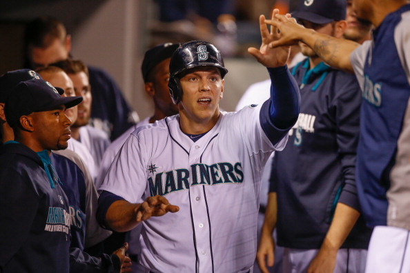 Logan Morrison #20 of the Seattle Mariners is congratulated by teammates after scoring on an RBI single off the bat of Austin Jackson in the third inning against the Toronto Blue Jays at Safeco Field on August 12, 2014 in Seattle, Washington.  (Photo by Otto Greule Jr/Getty Images).