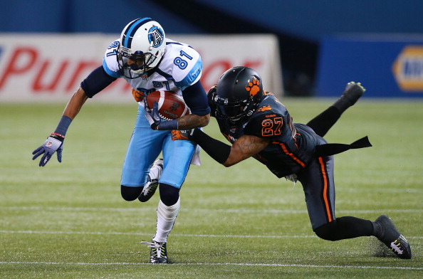  J.R. LaRose #27 of the BC Lions makes a tackle on Jason Barnes #81 of the Toronto Argonauts during their game at Rogers Centre on August 17, 2014 in Toronto, Canada. (Photo by Dave Sandford/Getty Images).