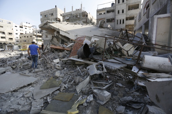 A Palestinian man walks though Mohammed al-Ghul's house after it was targeted in an Israeli airstrike in Gaza City on August 25, 2014. One of Sunday's air strikes killed Hamas financial official Mohammed al-Ghul as he was travelling by car in Gaza City. An Israeli air raid in Gaza left two Palestinians dead overnight, taking the number of killed Palestinians in the seven-week conflict to 2,122, Palestinian sources said. 