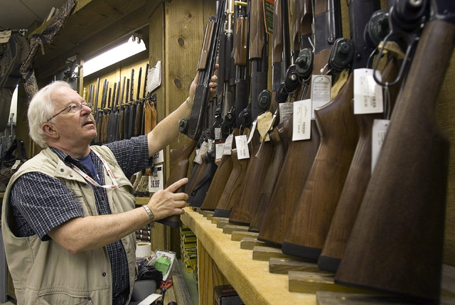 Louis Andre Gregoire replaces a shotgun in the rack in a downtown Montreal outdoor store in this file image.