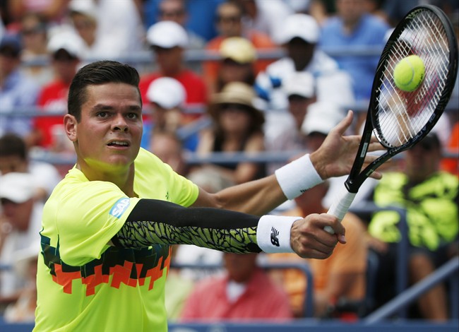 Milos Raonic, of Canada, returns a shot against Victor Estrella Burgos, of Dominican Republic, during the third round of the 2014 U.S. Open tennis tournament, Saturday, Aug. 30, 2014, in New York. (AP Photo/Kathy Willens).