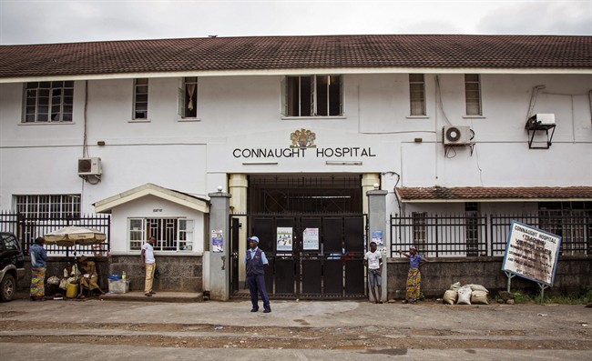A security guard stands outside the Connaught Hospital in Freetown, Sierra Leone, on Friday, Aug. 15, 2014 (AP Photo/Michael Duff)