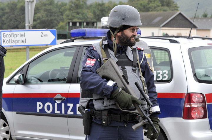Police stand near the villages of Grosspriel and Kollapriel some 90 kilometers west of Vienna, Austria, in this Tuesday, Sept. 17, 2013 file photo. 