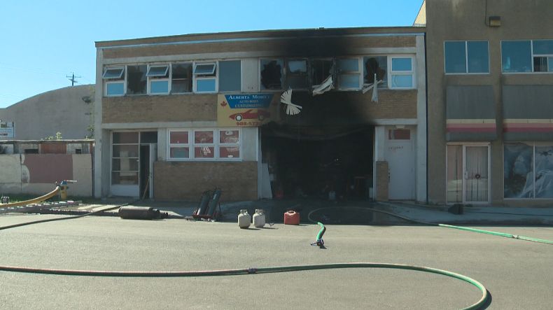 An Edmonton auto body customizing shop is damaged by a fire, Monday, August 11, 2014. 