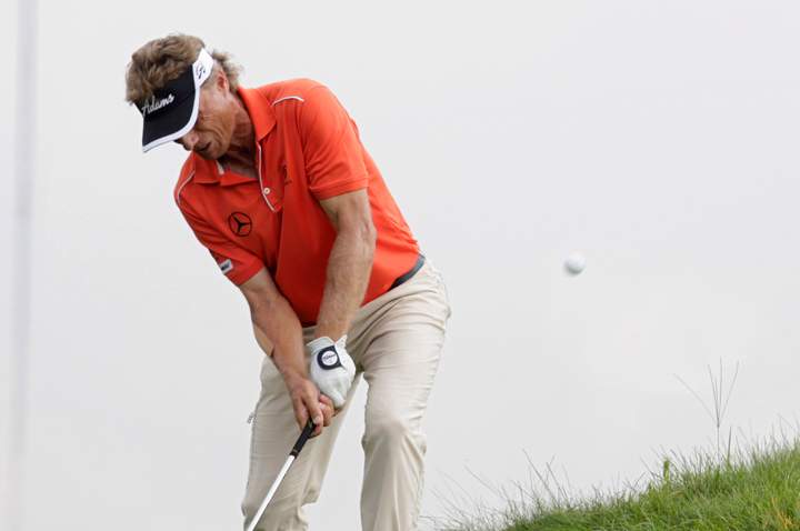Bernhard Langer, of Germany, chips out of the deep rough at the edge of the 18th green during the third round of the Champions Tour 3M Championship golf tournament at TPC Twin Cities in Blaine, Minn., Sunday, Aug. 3, 2014.