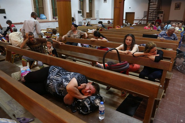 Displaced Iraqi Christians settle at St. Joseph Church in Irbil, northern Iraq, Thursday, Aug. 7, 2014.
