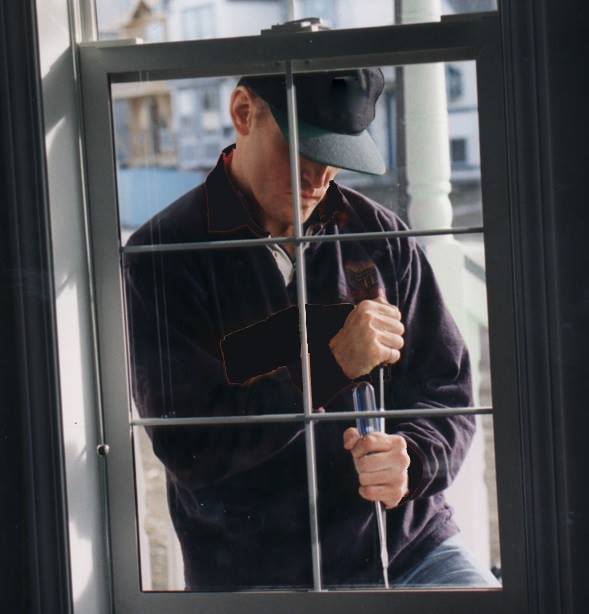 FILE: A photo of a suspect attempting to break in to a home. 