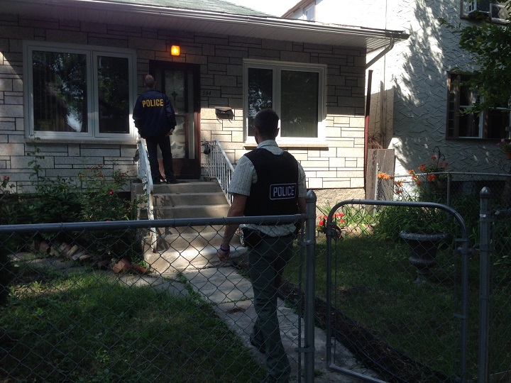 Police on Langside Street in Winnipeg, investigating the death of Tina Fontaine, on Wednesday August 20, 2014.