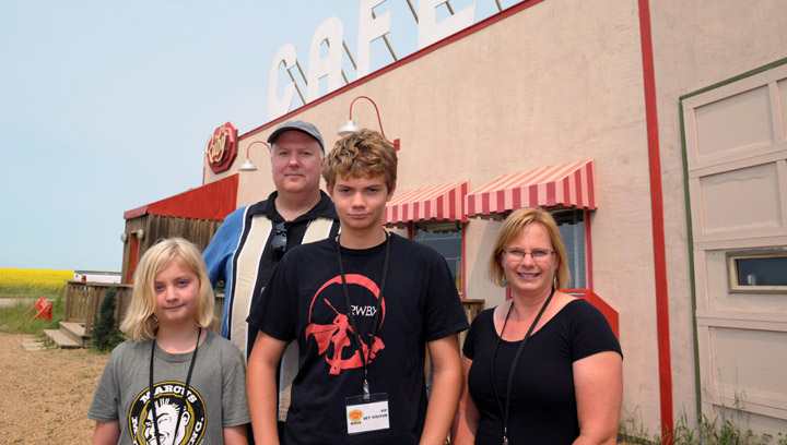 Aidan, Ben, Ian and Angela Garvie (left to right) pose in front of The Ruby Cafe on the set of Corner Gas in Rouleau, Sask., on Wednesday, July 16, 2014. The Californian family and Corner Gas fans gave money to the movie via a Kickstarter campaign and were rewarded with a day on the set during filming.